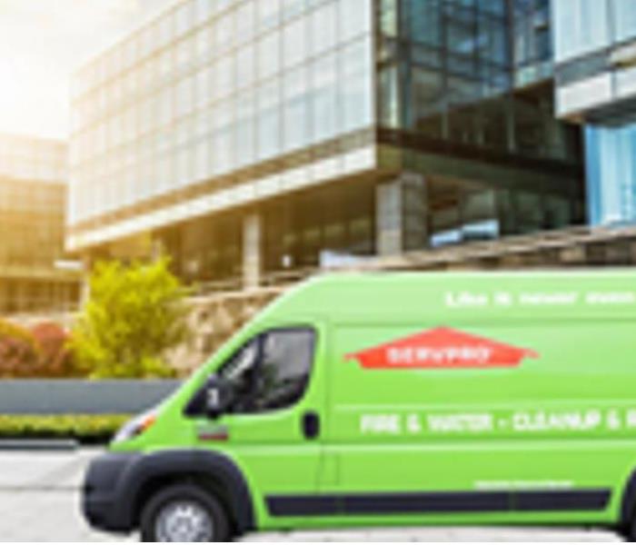 A photo showing a SERVPRO van in front of a commercial building
