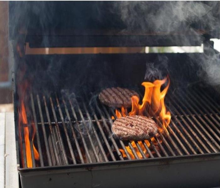 Fire beginning on a grill from hamburger grease